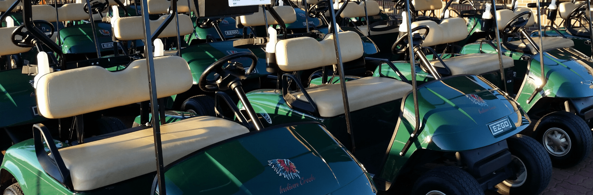 Green golf carts with Indian Creek logos on hood.