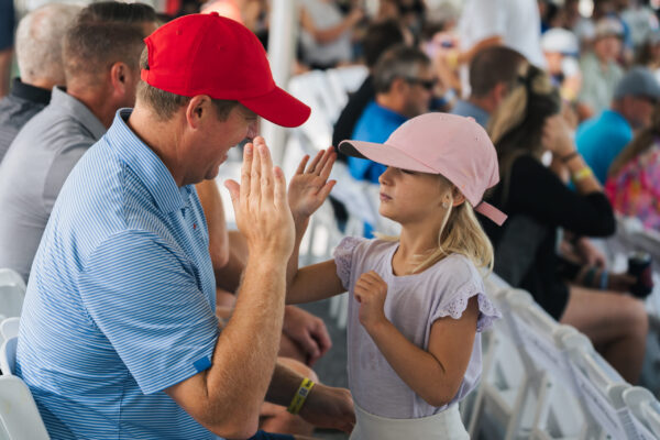 Spectators high five during the Pinnacle Bank Championship